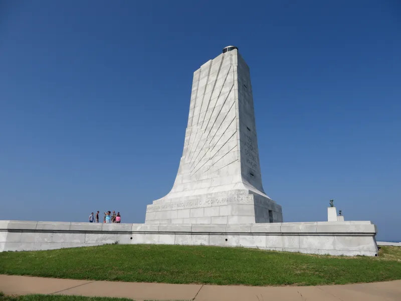 Wright Brothers National Memorial tower up close with Art Deco details against clear sky
