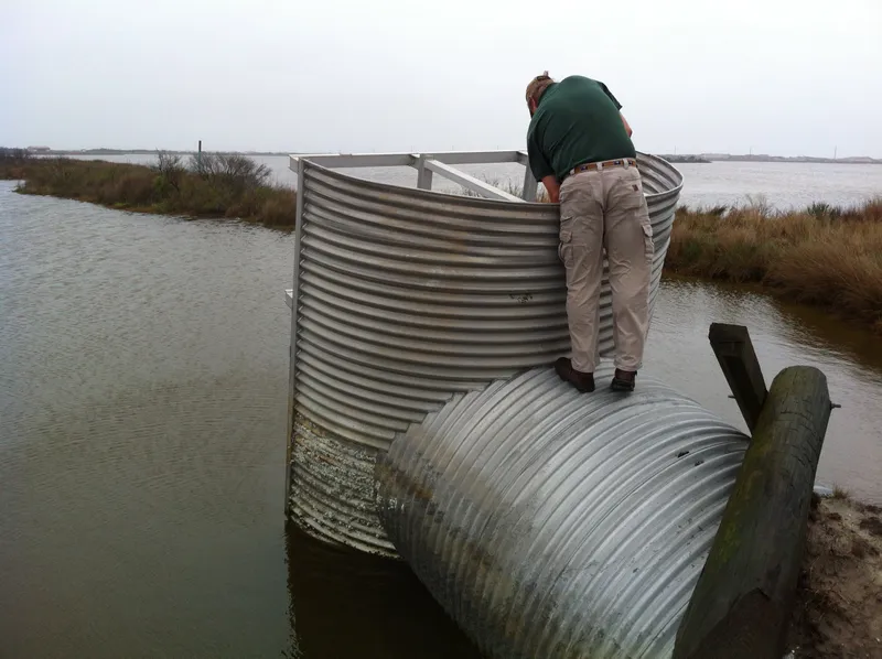 Water control structure at Pea Island National Wildlife Refuge with managed wetlands and the Pamlico Sound near Salvo