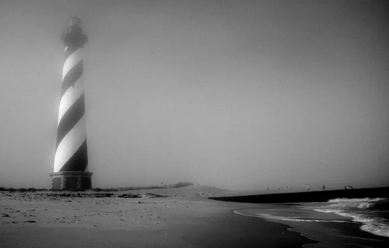 Cape Hatteras Lighthouse standing in fog on its original beach location in 1998, before the historic relocation move