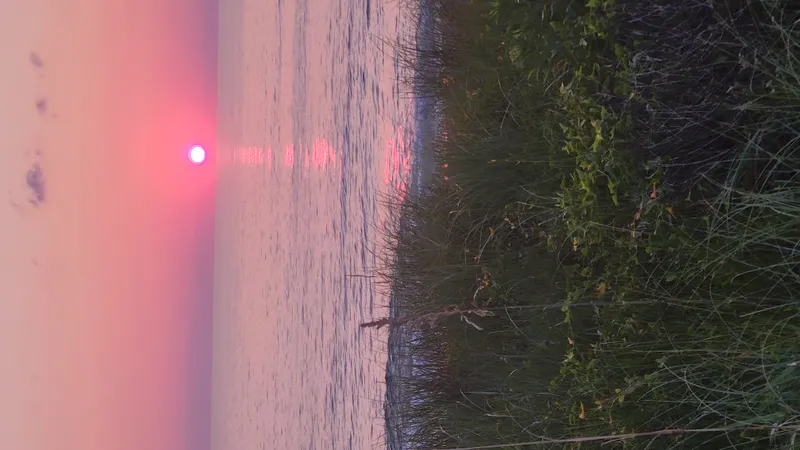 Sunrise continues over the Atlantic Ocean near Kitty Hawk with warm golden tones