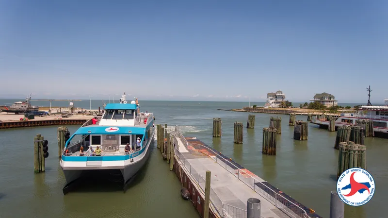 Aerial drone view of the narrow barrier island at southern Hatteras showing the road, beach houses, and ocean on both sides