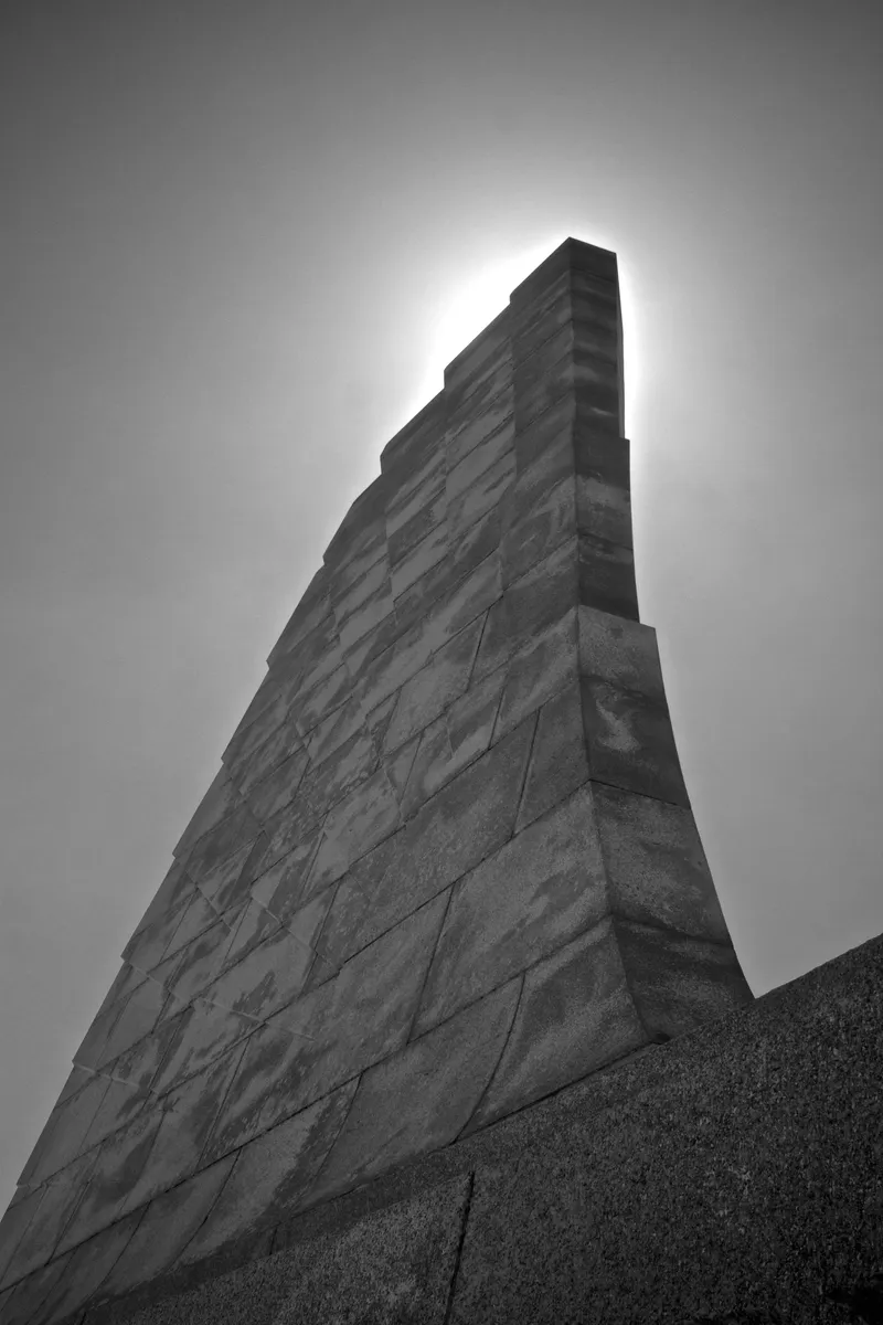 Wright Brothers National Memorial monument on Big Kill Devil Hill against blue sky