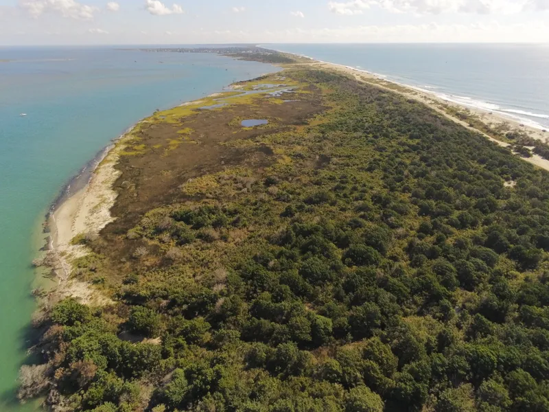 Aerial view looking north along the narrow southern tip of Hatteras Island with ocean on the right and Pamlico Sound on the left