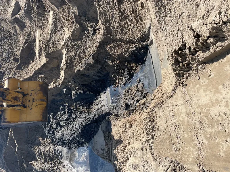 Beach access point at Buxton on Hatteras Island showing sandy path to the ocean with dune fencing and sea oats