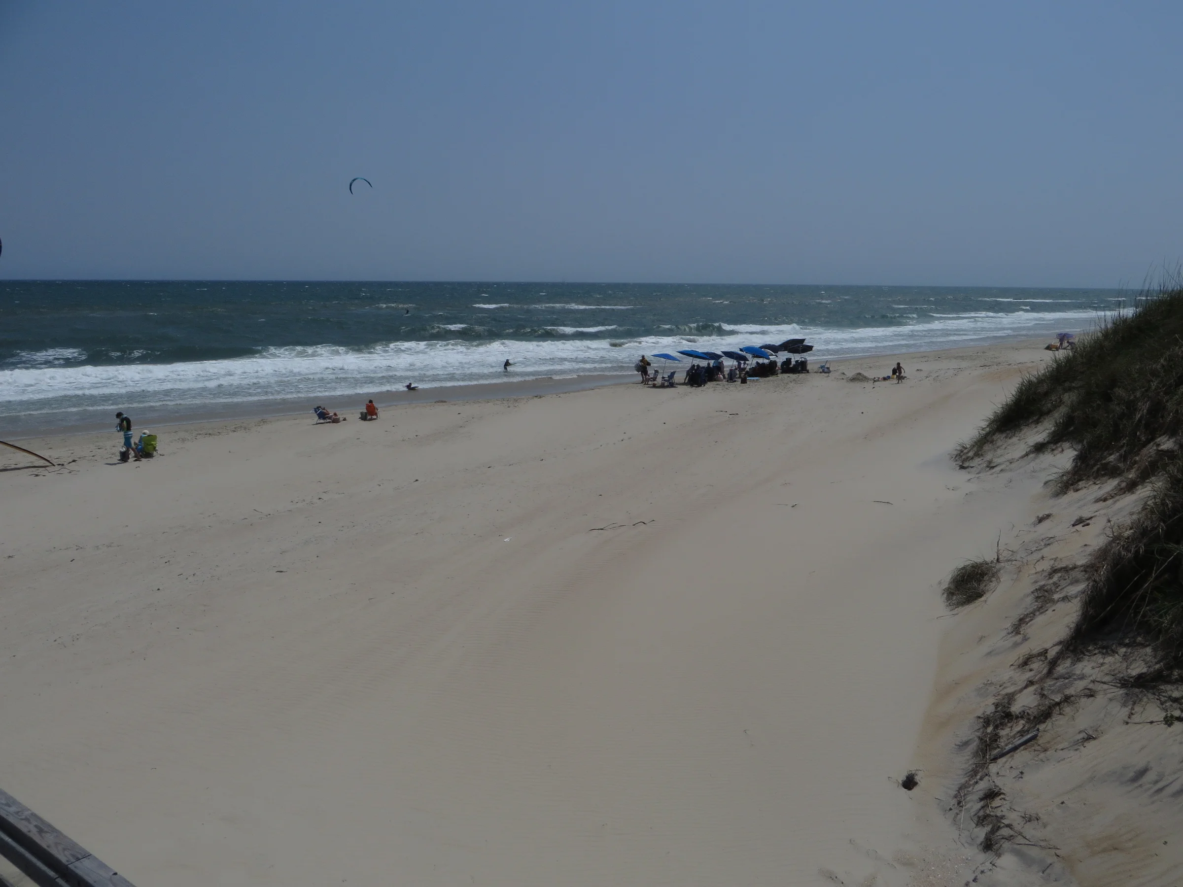 Wide open beach along Cape Hatteras National Seashore near Salvo with ocean waves, sand, and sea grass on the dunes