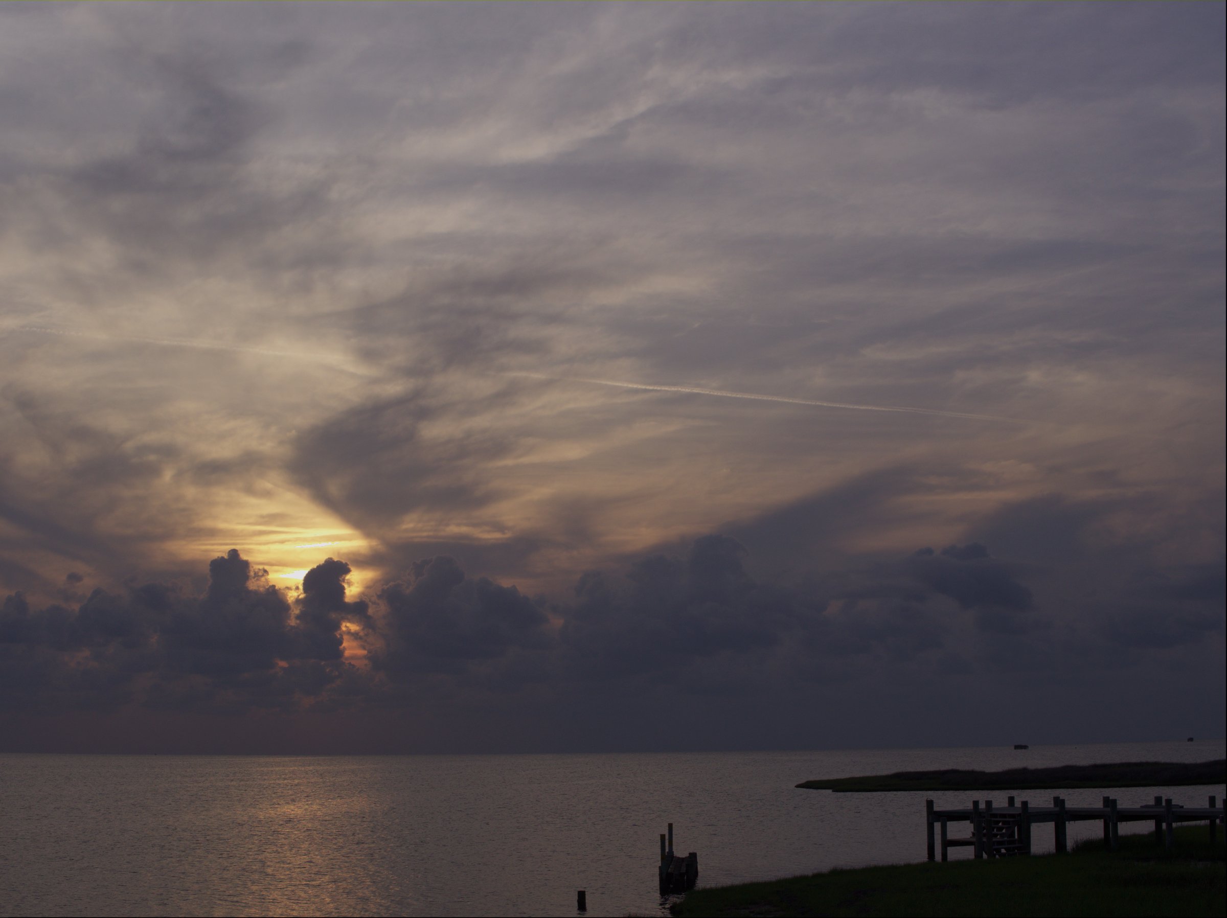 Vivid sunset over the sound at Salvo on Hatteras Island, warm orange and purple sky reflected on calm water