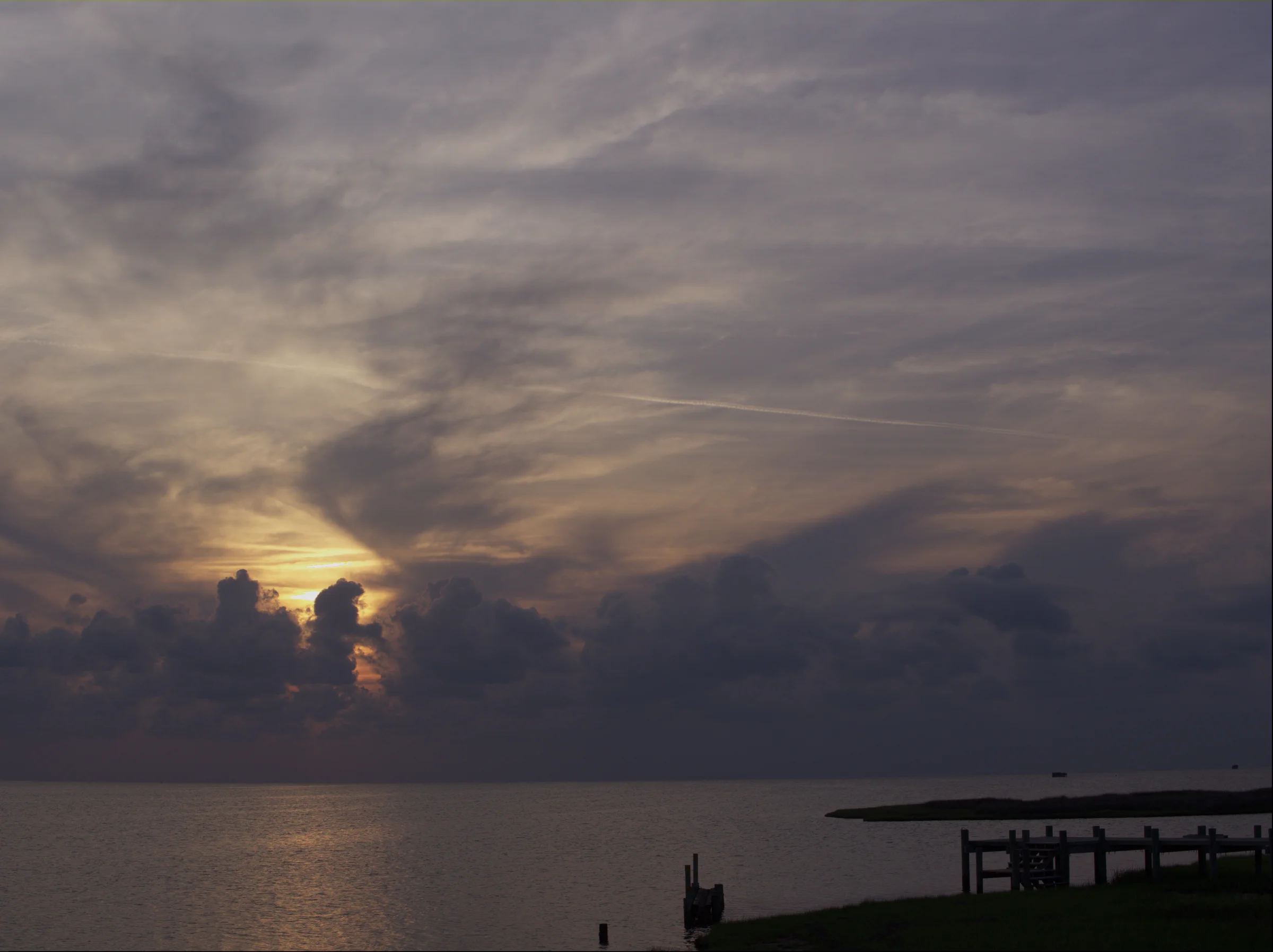 Vivid sunset over the sound at Salvo on Hatteras Island, warm orange and purple sky reflected on calm water
