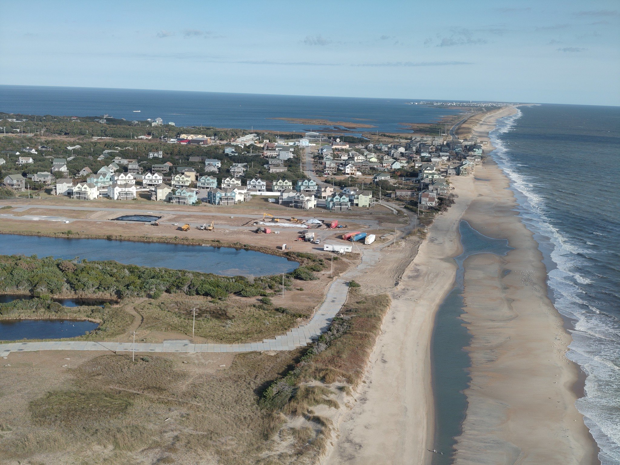 Wide sandy beach at Buxton on Hatteras Island with ocean waves and dunes under partly cloudy November sky